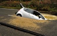 Car Swallowed by Gaping Hole in Road Caused by a Burst Water Main, Surrey, Britain - 05 Oct 2011