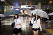 Girls with umbrellas at night