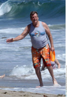 Actor RYAN O'NEAL playing frisbee on the beach in Malibu