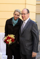 CPE/Prince Albert and Princess Charlene of Monaco giving gifts to old people at Monaco Red Cross