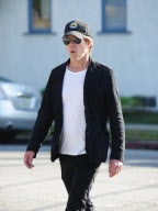 Kevin Bacon Dresses in Dark Clothes on a Sunny Day
