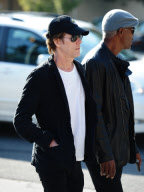 Kevin Bacon Dresses in Dark Clothes on a Sunny Day