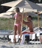 51 year old actress Rita Rusic shows she still has a great beach body to rival ladies twenty years her junior..The movie producer got her necklace tangled up but her boyfriend came to her rescue and straightened it out for her. Miami Beach Fl 