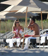 51 year old actress Rita Rusic shows she still has a great beach body to rival ladies twenty years her junior..The movie producer got her necklace tangled up but her boyfriend came to her rescue and straightened it out for her. Miami Beach Fl 