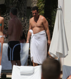 Adam Sandler and his wife Jackie take their daughters Sadie and Sunny by the pool whilst on holiday in Miami