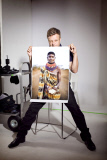 Rankin in his studio holding one of his photographs of a member of the tribal Turkana community in Kenya.