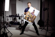 Rankin in his studio holding one of his photographs of a member of the tribal Turkana community in Kenya.