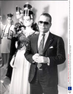 Karl Lagerfeld 1987 Chanel Dress Designer Karl Lagerfeld With Some Of His Creations Exhibited At Sotheby's. Also Portraits In Front Of A Montage....fashion Designer
