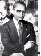 Karl Lagerfeld 1987 Chanel Dress Designer Karl Lagerfeld With Some Of His Creations Exhibited At Sotheby's. Also Portraits In Front Of A Montage....fashion Designer