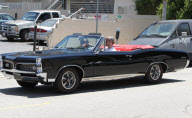 Justin Timberlake driving his vintage GTO with a mystery brunette