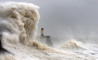 Gewaltige Brecher schlagen gegen den Leuchtturm von Porthcawl an der Küste von South Wales