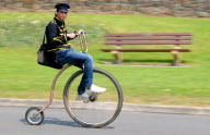 Man starts own Penny Farthing bicycle postal service in Bude, Cornwall, Britain - May 2012