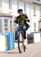 Man starts own Penny Farthing bicycle postal service in Bude, Cornwall, Britain - May 2012