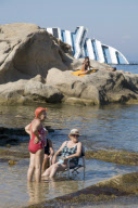 Bathers on beach of Scalettino near the wreck of Costa Concordia, Isola Del Giglio, Italy - 07 Jul 2012