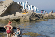 Bathers on beach of Scalettino near the wreck of Costa Concordia, Isola Del Giglio, Italy - 07 Jul 2012