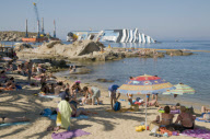 Bathers on beach of Scalettino near the wreck of Costa Concordia, Isola Del Giglio, Italy - 07 Jul 2012