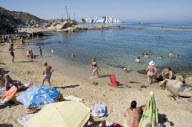 Bathers on beach of Scalettino near the wreck of Costa Concordia, Isola Del Giglio, Italy - 07 Jul 2012