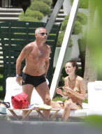 Italian musician Eros Ramazzotti relaxes poolside in Miami, Florida on August 12, 2012 