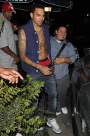 A bare chested Chris Brown leaving the Roxbury nightclub
