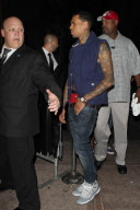 A bare chested Chris Brown leaving the Roxbury nightclub