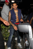 A bare chested Chris Brown leaving the Roxbury nightclub