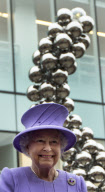 Britain's Queen Elizabeth II stands back..........