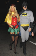 Paris Hilton and River Viiperi play superheros at a Halloween party