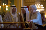 The Amir Sheikh Sabah Al-Ahmad Al-Jaber Al-Sabah of Kuwait (L) look at a gold sword with Queen Elizabeth II  in the Green room at Windsor Castle during a three-day state visit on 27 November , 2012 in Windsor, England. 