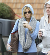 Sophie Monk hiding behind a hoodie