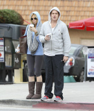 Sophie Monk hiding behind a hoodie