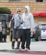 Sophie Monk hiding behind a hoodie