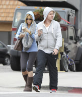 Sophie Monk hiding behind a hoodie