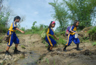 Children forced to cross rivers and walk on muddy paths to get to school, Indonesia - 14 Dec 2012