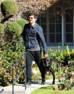 A Happy Orlando Bloom Leaves A Friends House With His Pup