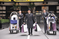 Savoy hotel doormen taking clothing and products to be used at the EE BAFTA awards, to the styling suites, London, Britain-8th Feb 2012