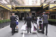 Savoy hotel doormen taking clothing and products to be used at the EE BAFTA awards, to the styling suites, London, Britain-8th Feb 2012