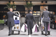 Savoy hotel doormen taking clothing and products to be used at the EE BAFTA awards, to the styling suites, London, Britain-8th Feb 2012