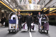 Savoy hotel doormen taking clothing and products to be used at the EE BAFTA awards, to the styling suites, London, Britain-8th Feb 2012