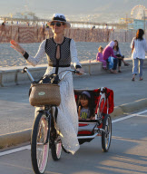 Johnny Hallyday and family riding bikes with Jean Reno