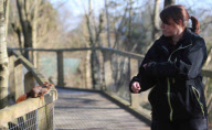 Hazel the pickpocketing red squirrel steals nuts from out a person's pocket at Escot Park, Devon, Britain - 14 Mar 2013