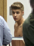 Half-naked Justin Bieber goes through airport security in Poland NO USE IN POLAND