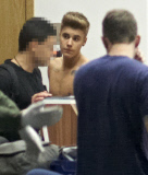 Half-naked Justin Bieber goes through airport security in Poland NO USE IN POLAND