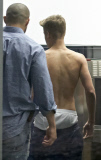 Half-naked Justin Bieber goes through airport security in Poland NO USE IN POLAND
