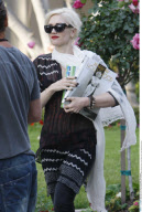 GWEN STEFANI carries a book about the screen legend Jean Harlow