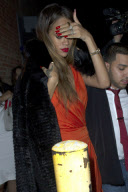 Rihanna looks stunning in orange as she shields her eyes from cameras