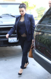 Kim Kardashian shows her pregnant belly with see-thru shirt at  meeting