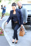 Kim Kardashian shows her pregnant belly with see-thru shirt at  meeting