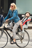 Naomi Watts is all smiles as she rides her bike to school