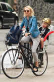 Naomi Watts is all smiles as she rides her bike to school