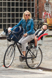 Naomi Watts is all smiles as she rides her bike to school